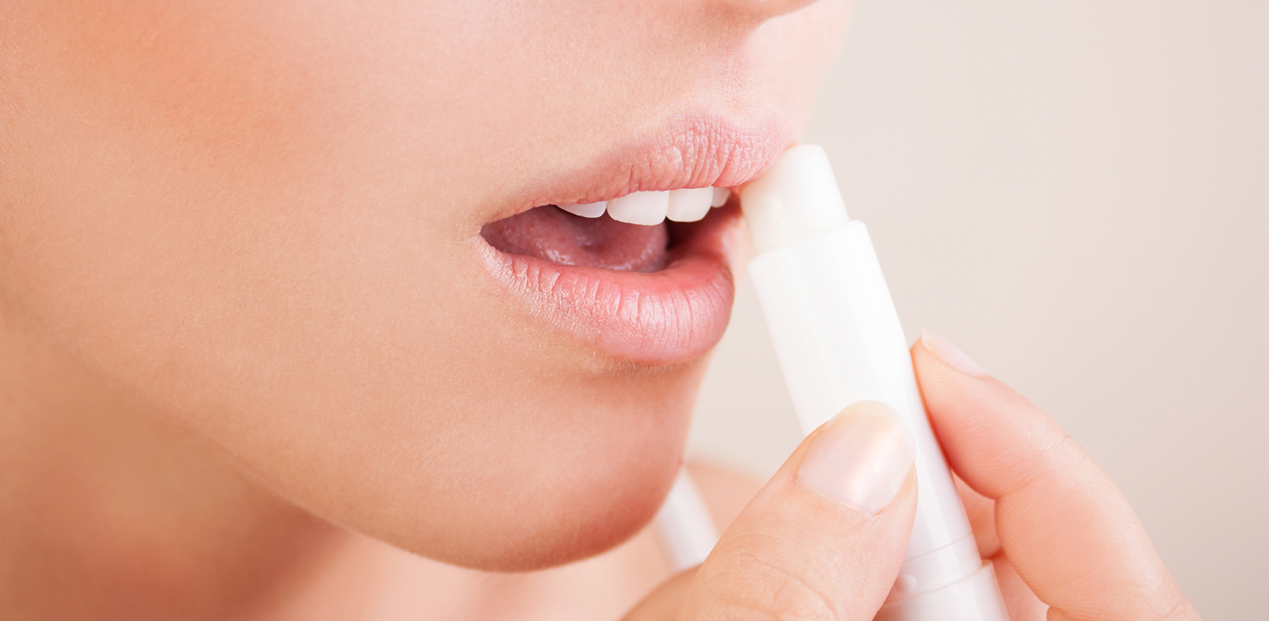 perfect-skin-care-routine-for-your-lips-woman-applying-lip-balm