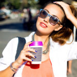 simple-tricks-to-make-perfume-last-all-day-woman-walking-outside-with-drink