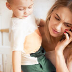 postpartum-hair-loss-what-to-do-mom-holding-child