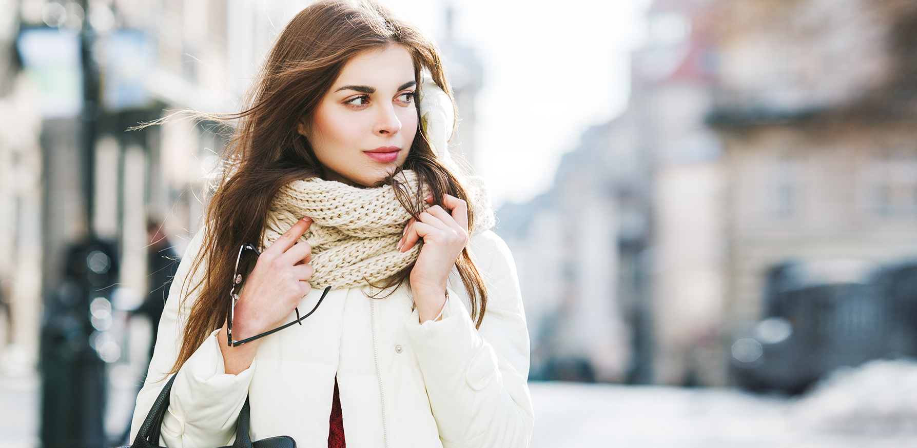 winter-skincare-woman-walknig-down-street-in-winter-in-scarf