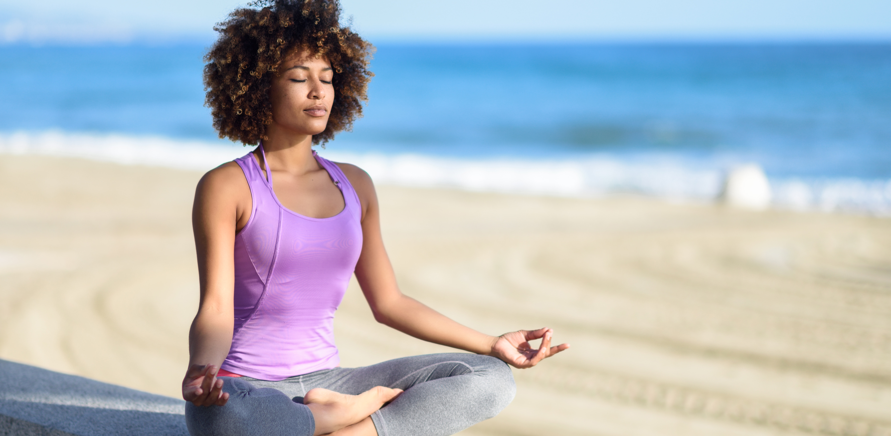 benefits-of-mindfulness-woman-meditating-yoga-on-beach
