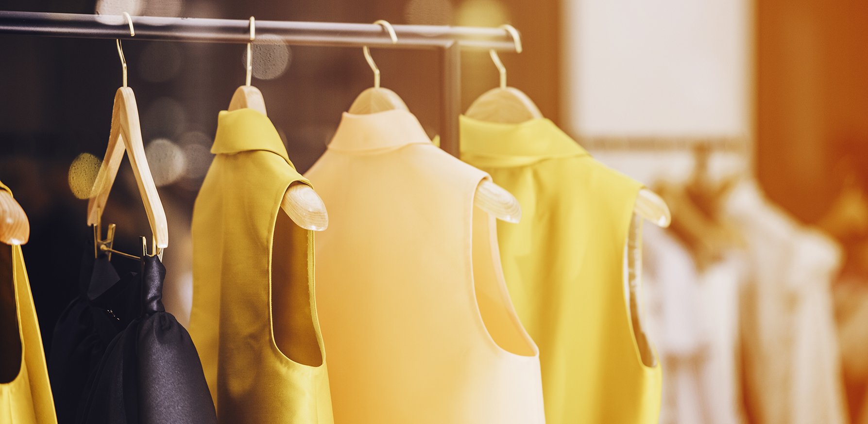 create-a-capsule-wardrobe-yellow-clothing-rack