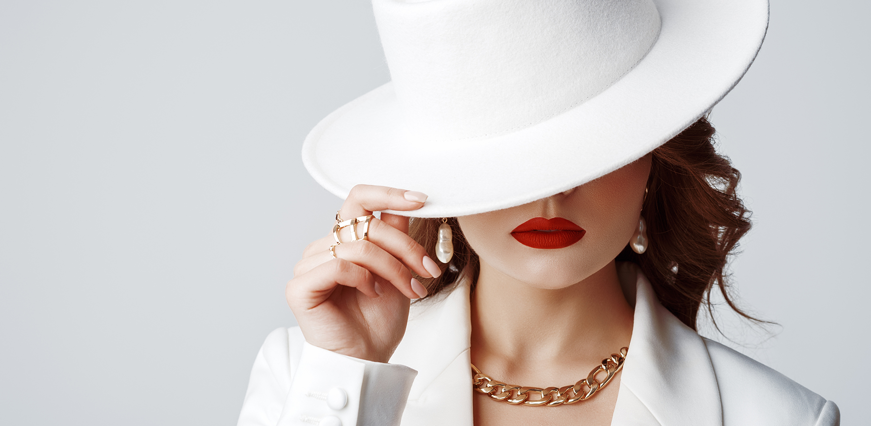 power-of-accessorizing-elevate-your-outfits-jewelry-woman-in-white-hat-tipping-it-down-fashion